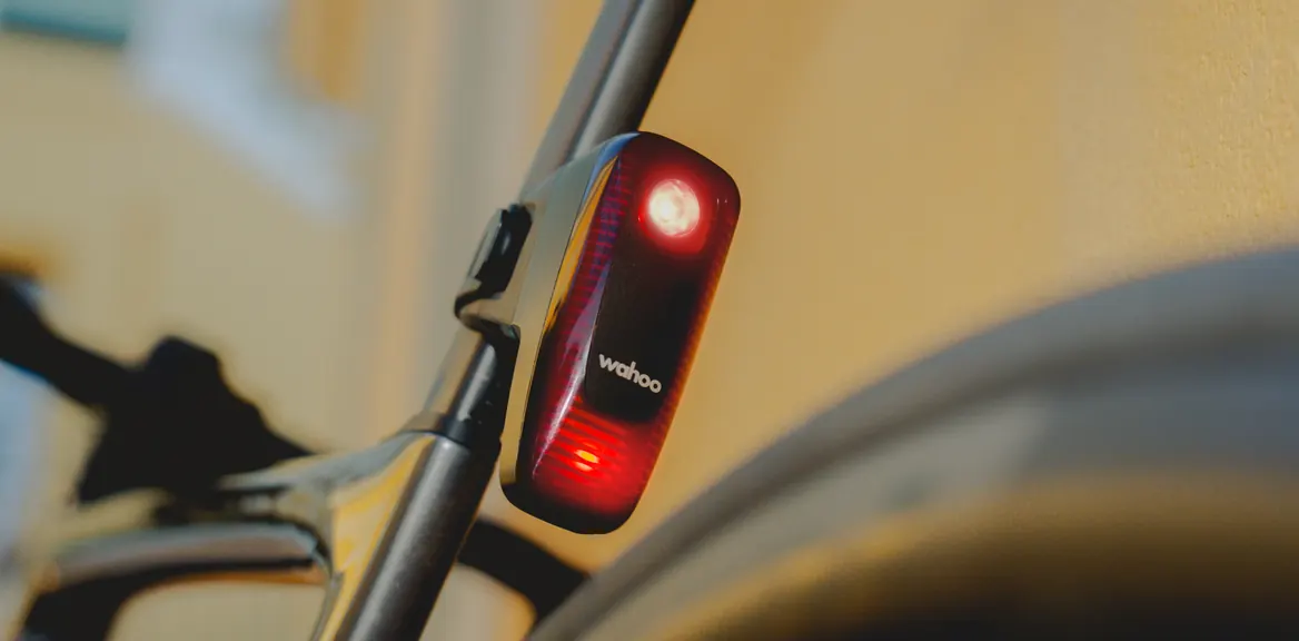 A TRACKR RADAR tail light on a seatpost as a car approaches from behind