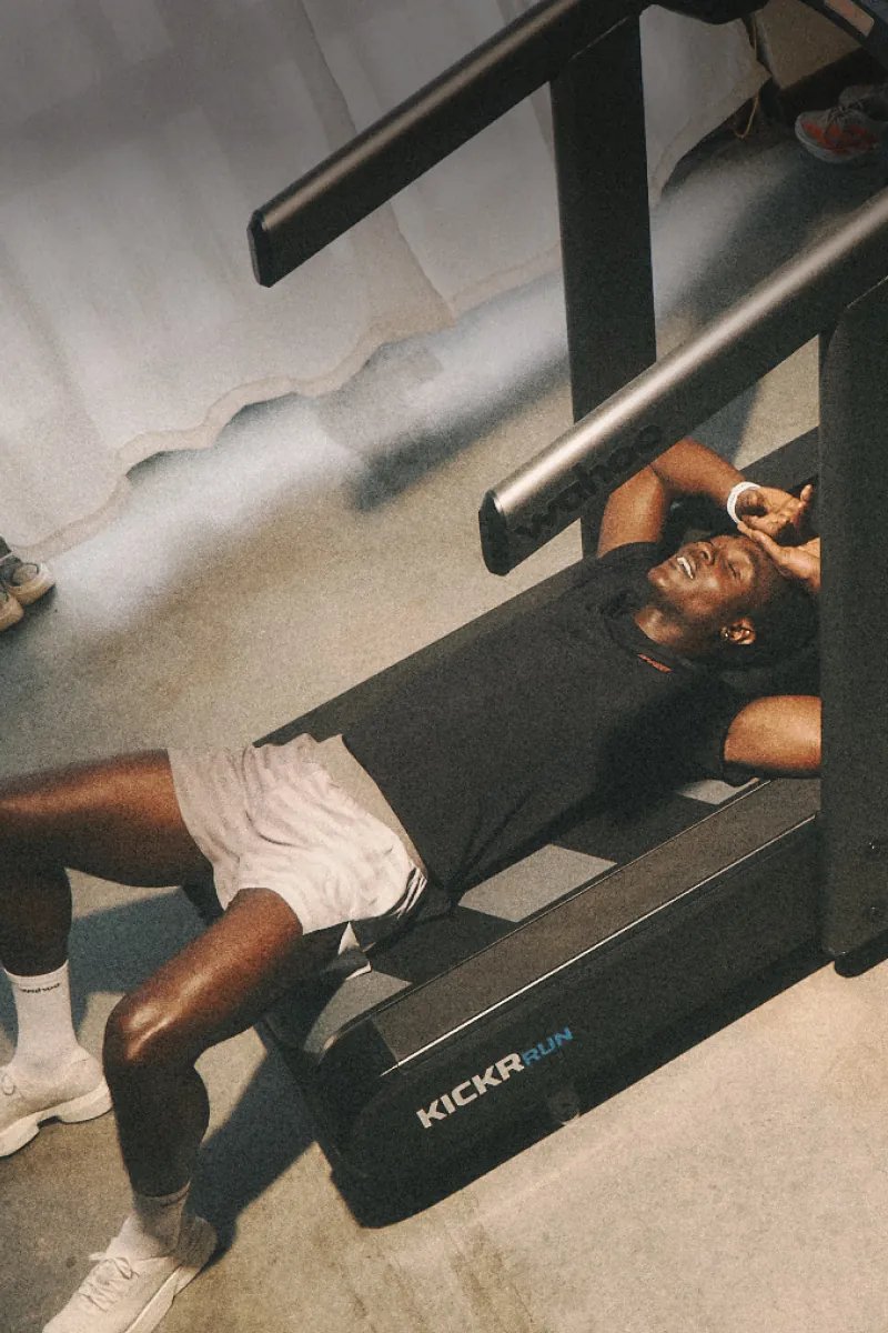 Exhausted runner laying on a treadmill